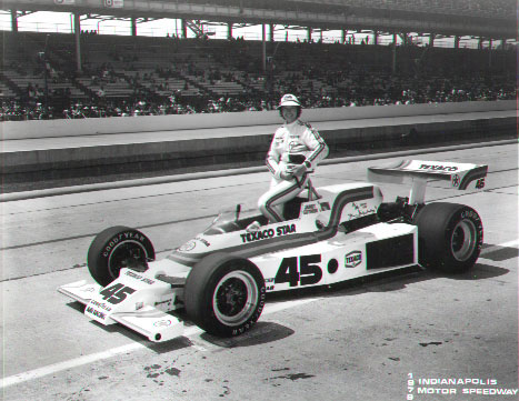 Janet Guthrie poses with her car